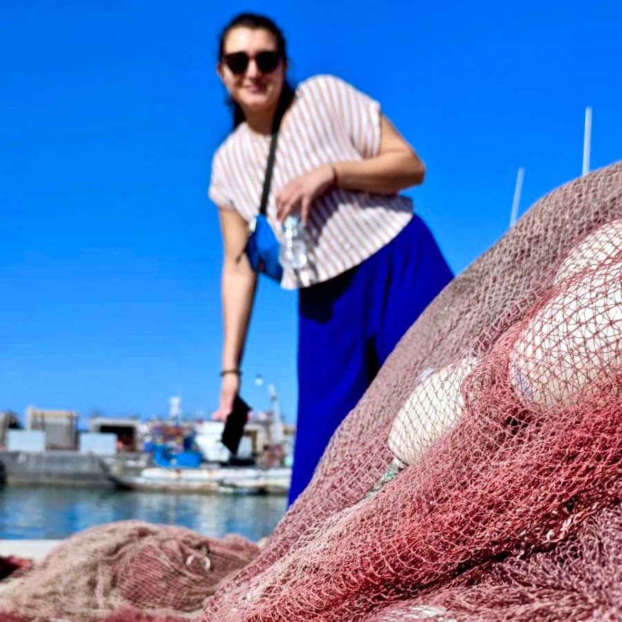 Jii from Fischnetz with Benefits behind used fishing nets in Morocco.